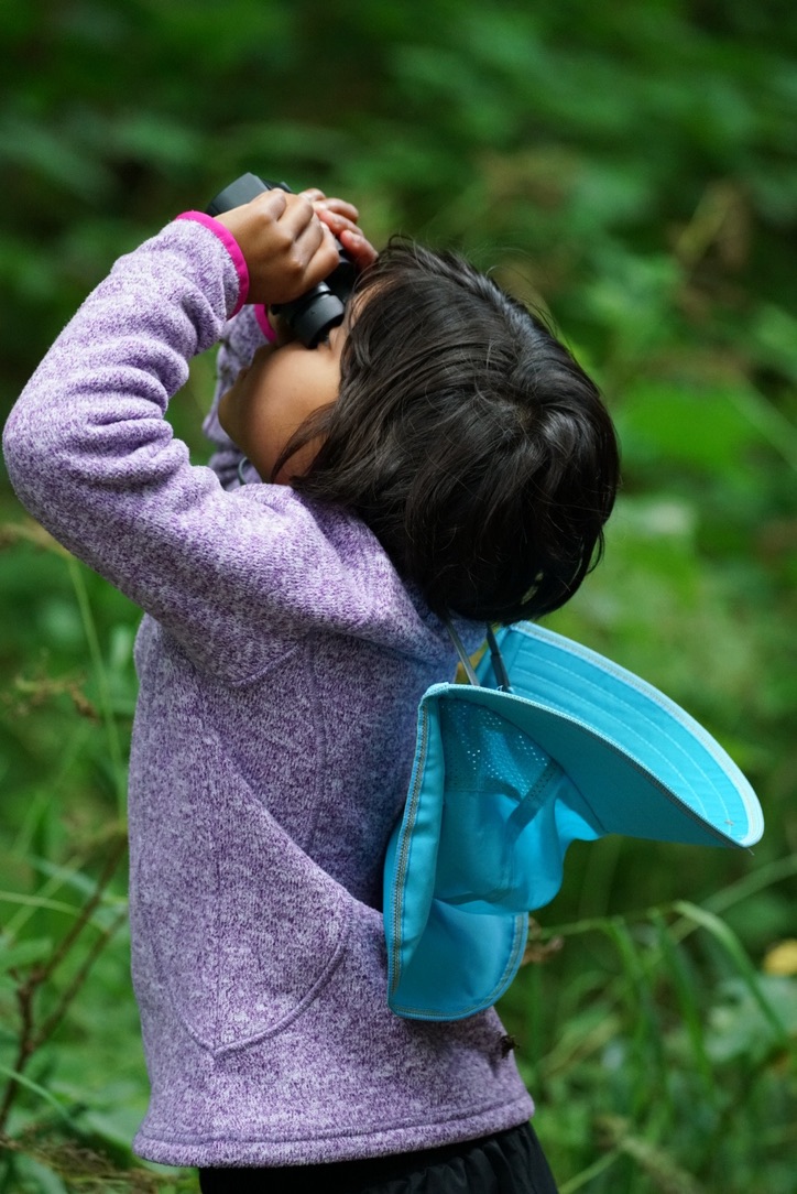 Child looking through binoculars